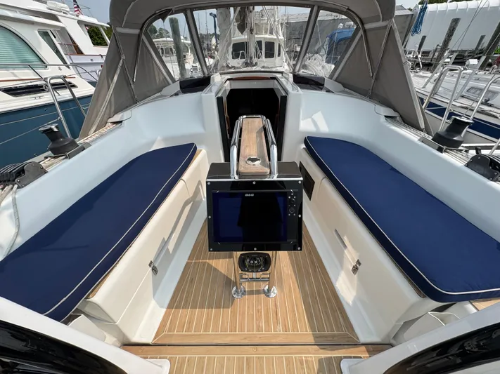 Dreamcatcher Yacht Photos Pics 2018 Hanse 348 yacht cockpit with blue seating and wooden flooring.