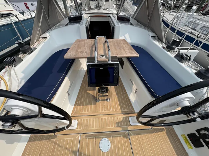 Dreamcatcher Yacht Photos Pics 2018 Hanse 348 yacht cockpit with dual steering wheels and wooden table.