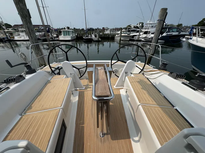 Dreamcatcher Yacht Photos Pics 2018 Hanse 348 sailboat cockpit with dual steering wheels, docked at a marina.