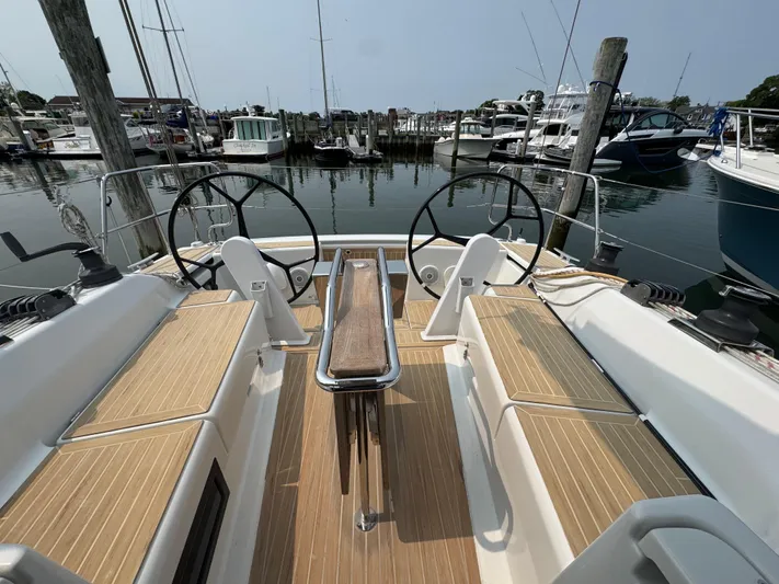 Dreamcatcher Yacht Photos Pics 2018 Hanse 348 sailboat cockpit with dual steering wheels in a marina setting.