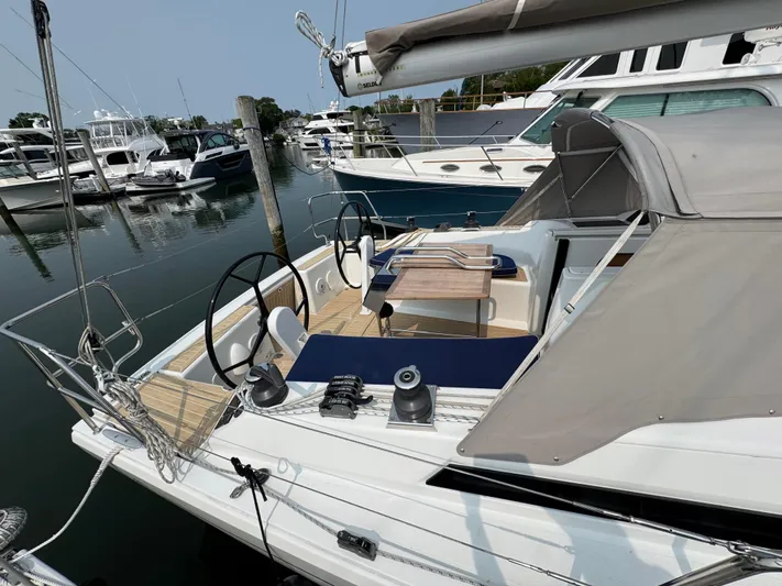 Dreamcatcher Yacht Photos Pics 2018 Hanse 348 sailboat docked at marina, featuring dual steering wheels and spacious deck.