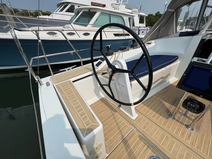 Dreamcatcher Yacht Photos Pics 2018 Hanse 348 yacht cockpit with steering wheel and wooden deck.