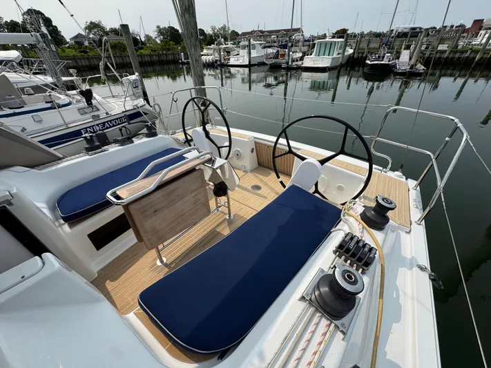 Dreamcatcher Yacht Photos Pics 2018 Hanse 348 yacht cockpit with dual steering wheels and blue seating, docked at marina.