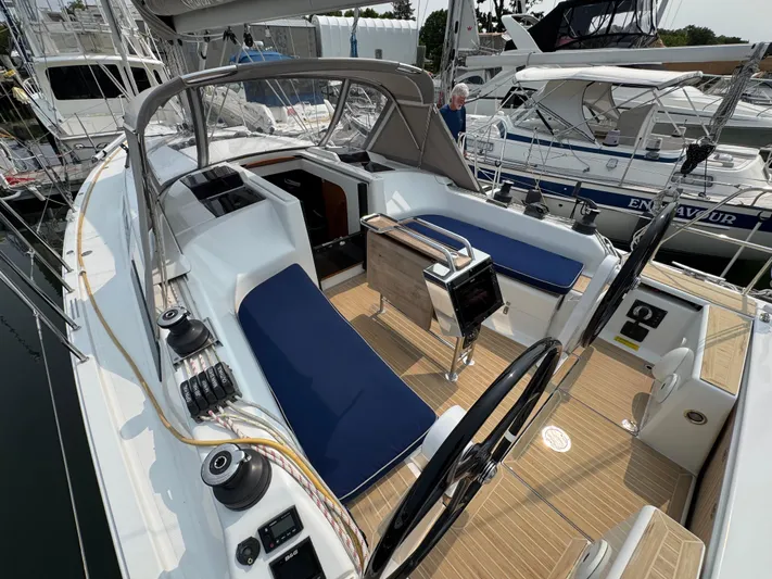Dreamcatcher Yacht Photos Pics 2018 Hanse 348 sailboat cockpit with blue seating and steering wheel, docked at marina.