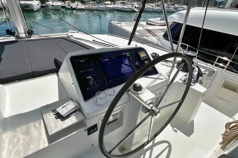 Take It Easy Yacht Photos Pics Steering wheel and control panel of 2018 Lagoon 450 F catamaran in marina.