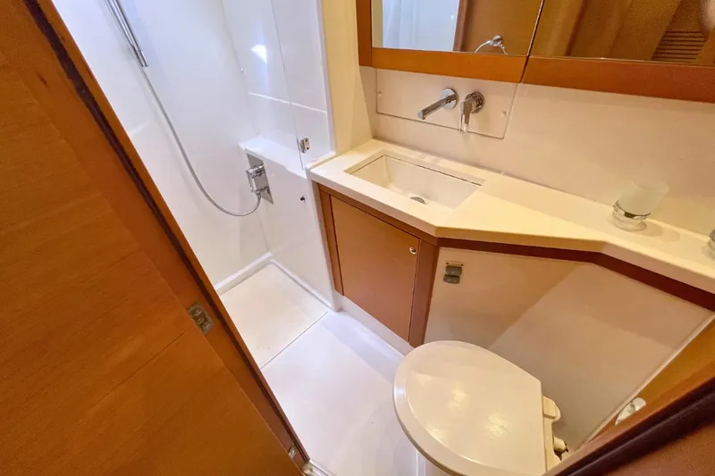 Take It Easy Yacht Photos Pics 2018 Lagoon 450 F yacht bathroom with shower, sink, and toilet.