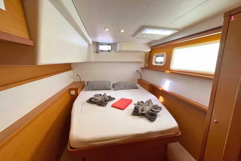 Take It Easy Yacht Photos Pics Luxurious cabin interior of 2018 Lagoon 450 F yacht with cozy bed and elegant decor.