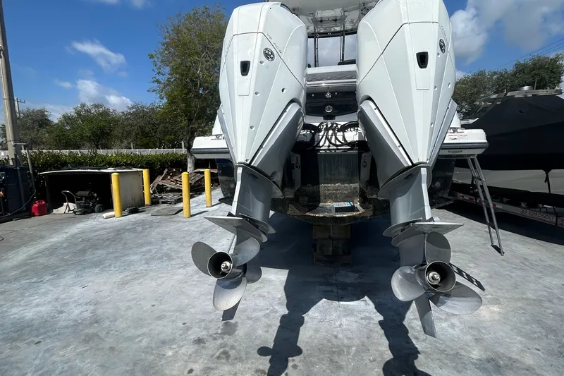 Aguabendita Yacht Photos Pics 2019 Monterey 345 Sport Yacht with dual outboard engines on a concrete surface.