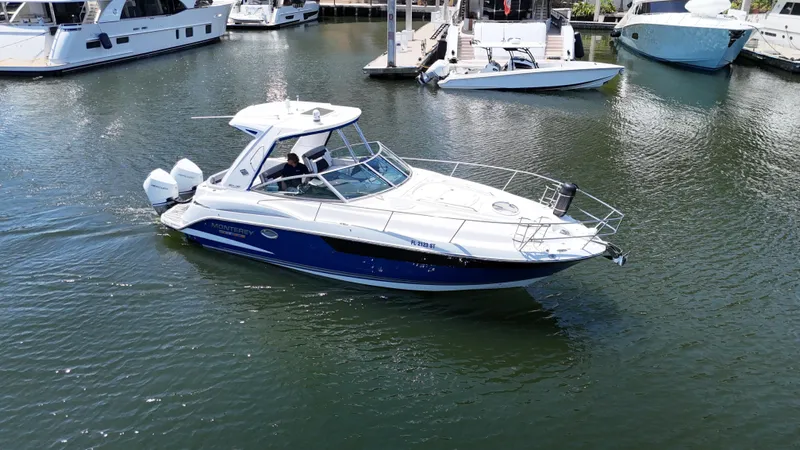 Aguabendita Yacht Photos Pics 2019 Monterey 345 Sport Yacht cruising in a marina, surrounded by other boats.
