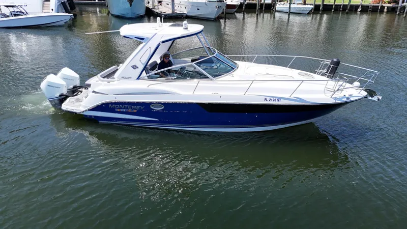 Aguabendita Yacht Photos Pics 2019 Monterey 345 Sport Yacht cruising on calm waters near a marina.
