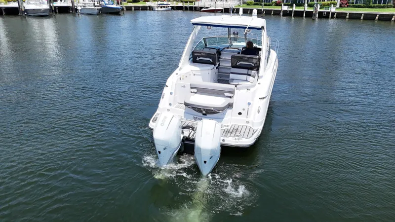 Aguabendita Yacht Photos Pics 2019 Monterey 345 Sport Yacht cruising on calm waters, rear view.