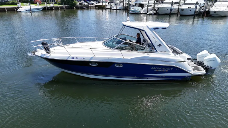 Aguabendita Yacht Photos Pics 2019 Monterey 345 Sport Yacht cruising on calm waters near a marina.