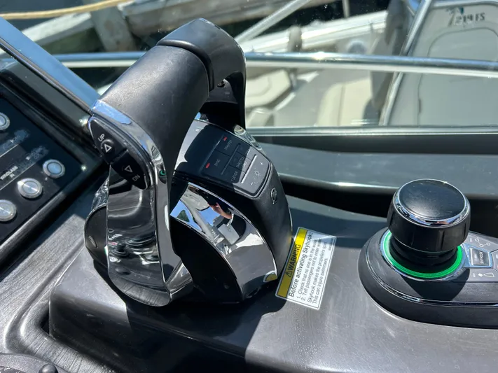 Aguabendita Yacht Photos Pics Throttle controls of a 2019 Monterey 345 Sport Yacht, featuring sleek design and modern technology.