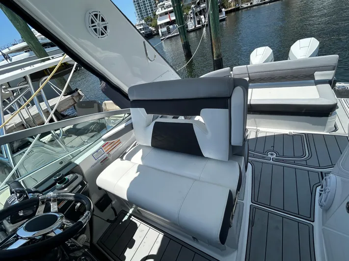 Aguabendita Yacht Photos Pics 2019 Monterey 345 Sport Yacht interior with sleek seating and modern design at a marina.