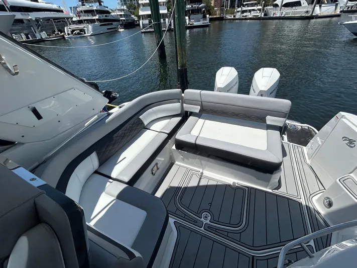 Aguabendita Yacht Photos Pics 2019 Monterey 345 Sport Yacht interior with sleek seating, docked at a marina.
