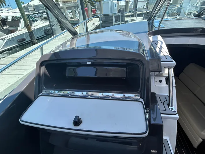 Aguabendita Yacht Photos Pics 2019 Monterey 345 Sport Yacht interior with open storage compartment, docked at marina.