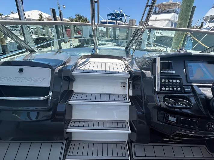 Aguabendita Yacht Photos Pics 2019 Monterey 345 Sport Yacht cockpit with stairs, dashboard, and marina view.