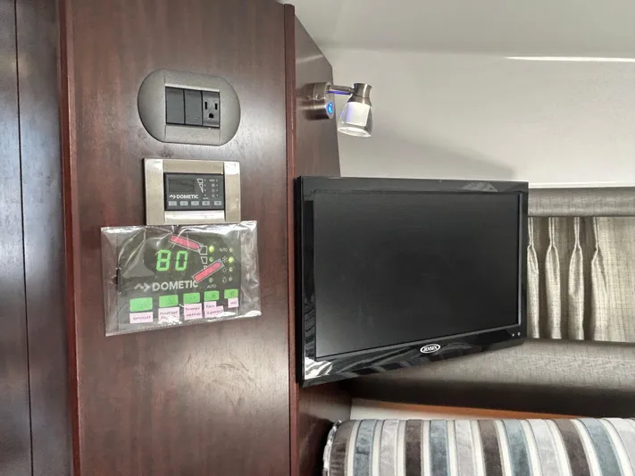 Aguabendita Yacht Photos Pics 2019 Monterey 345 Sport Yacht interior with TV, control panel, and modern lighting.