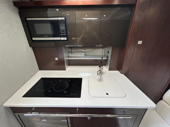 Aguabendita Yacht Photos Pics 2019 Monterey 345 Sport Yacht kitchen with microwave, stovetop, and sink.