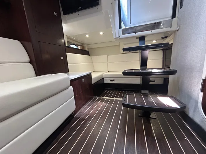 Aguabendita Yacht Photos Pics Luxurious interior of a 2019 Monterey 345 Sport Yacht with elegant seating and wooden flooring.