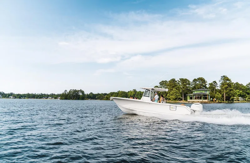  Yacht Photos Pics 2025 Sea Hunt Ultra 305 SE cruising on a scenic lake.