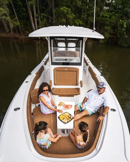  Yacht Photos Pics Family enjoying a meal on a 2025 Sea Hunt Ultra 305 SE boat.