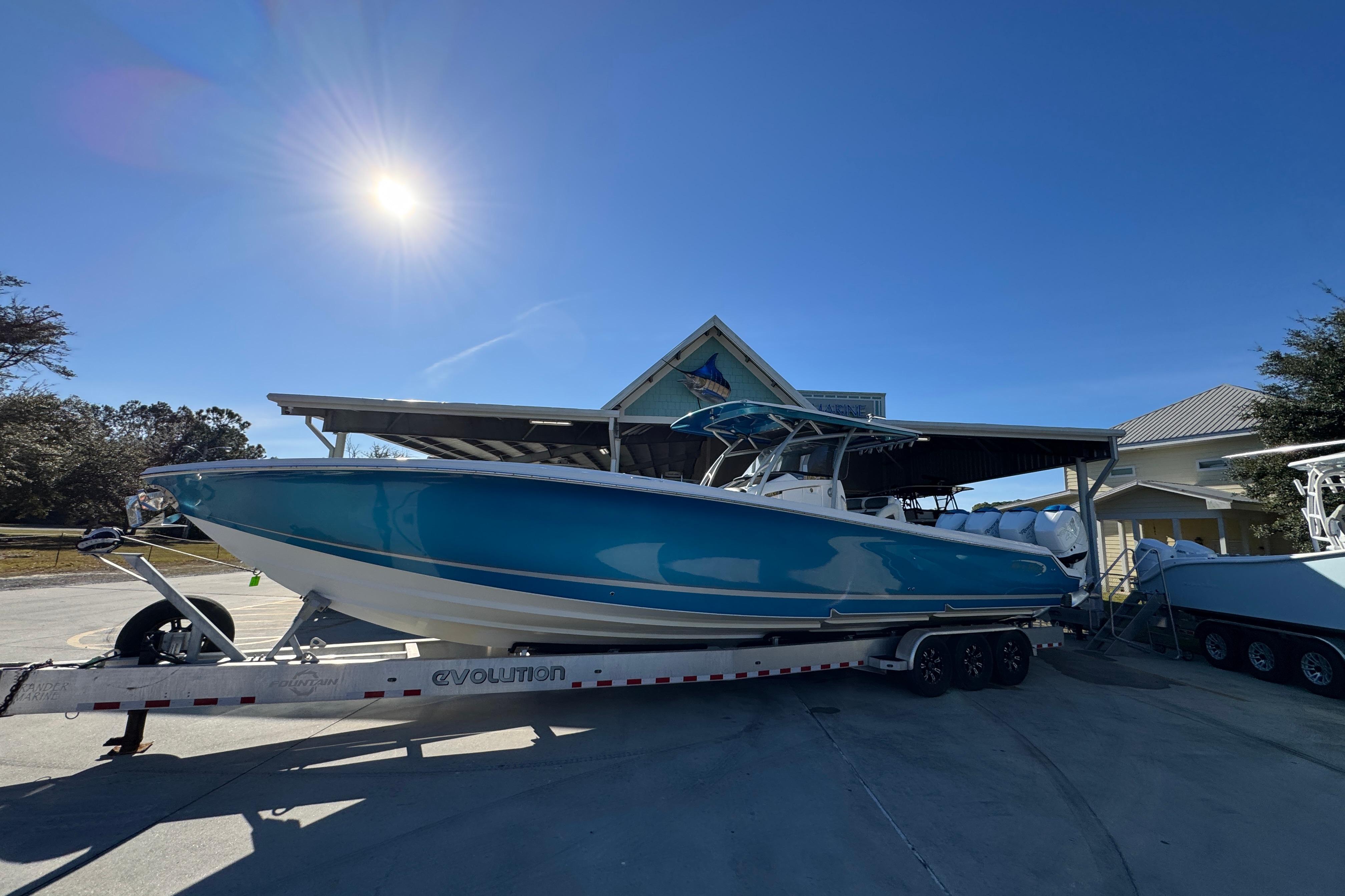 2016 Nor-Tech 390 Sport Center Console boat on trailer under sunny sky.
