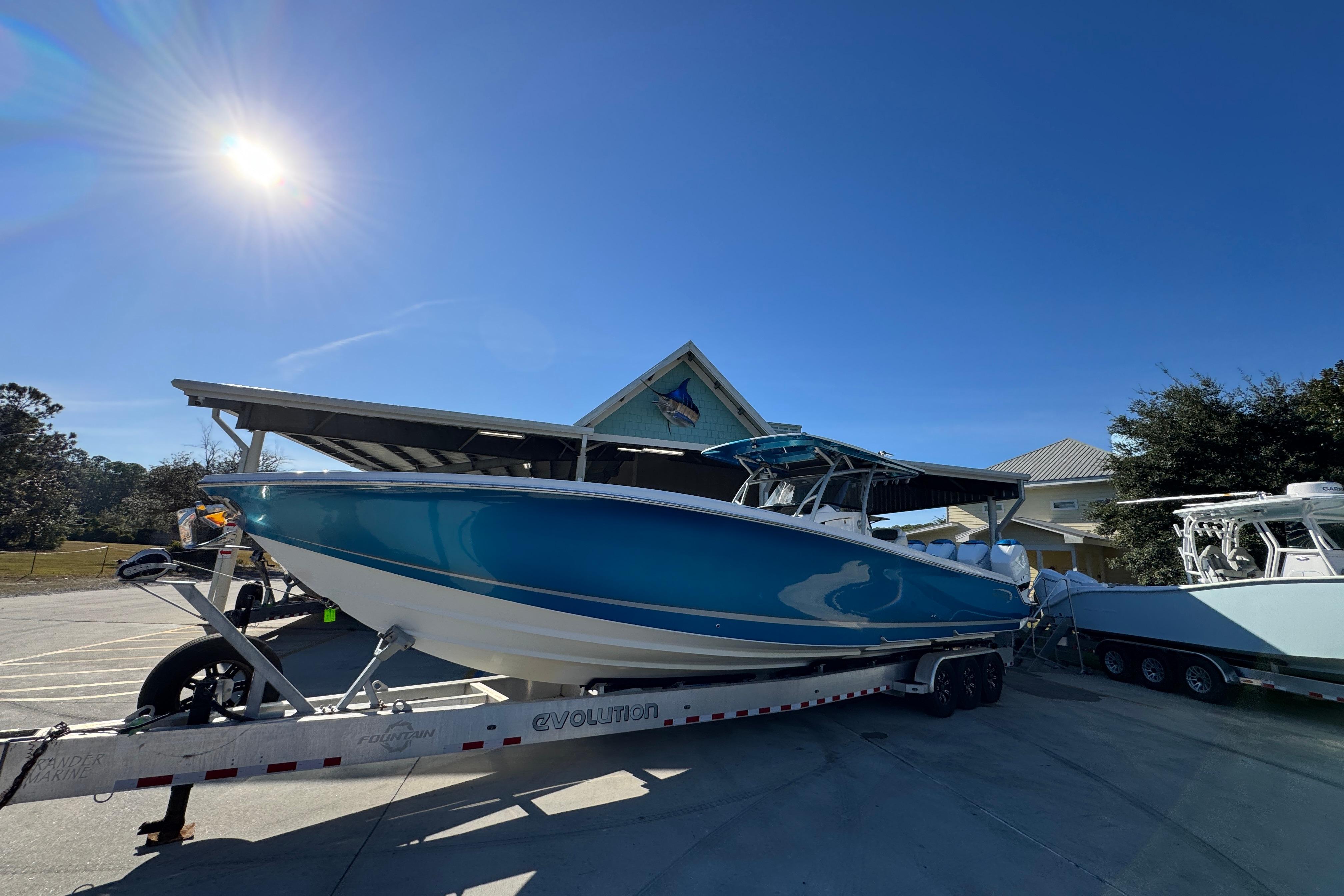 2016 Nor-Tech 390 Sport Center Console boat on trailer under clear blue sky.