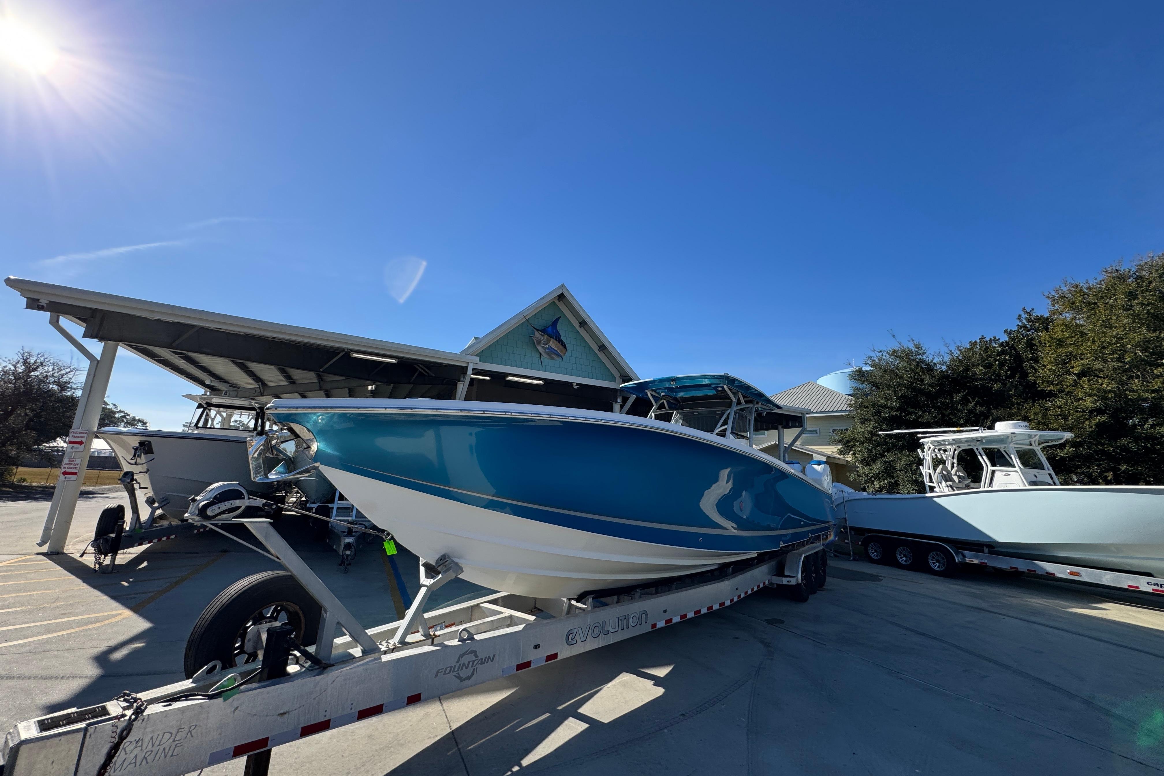 2016 Nor-Tech 390 Sport Center Console boat on trailer under clear blue sky.