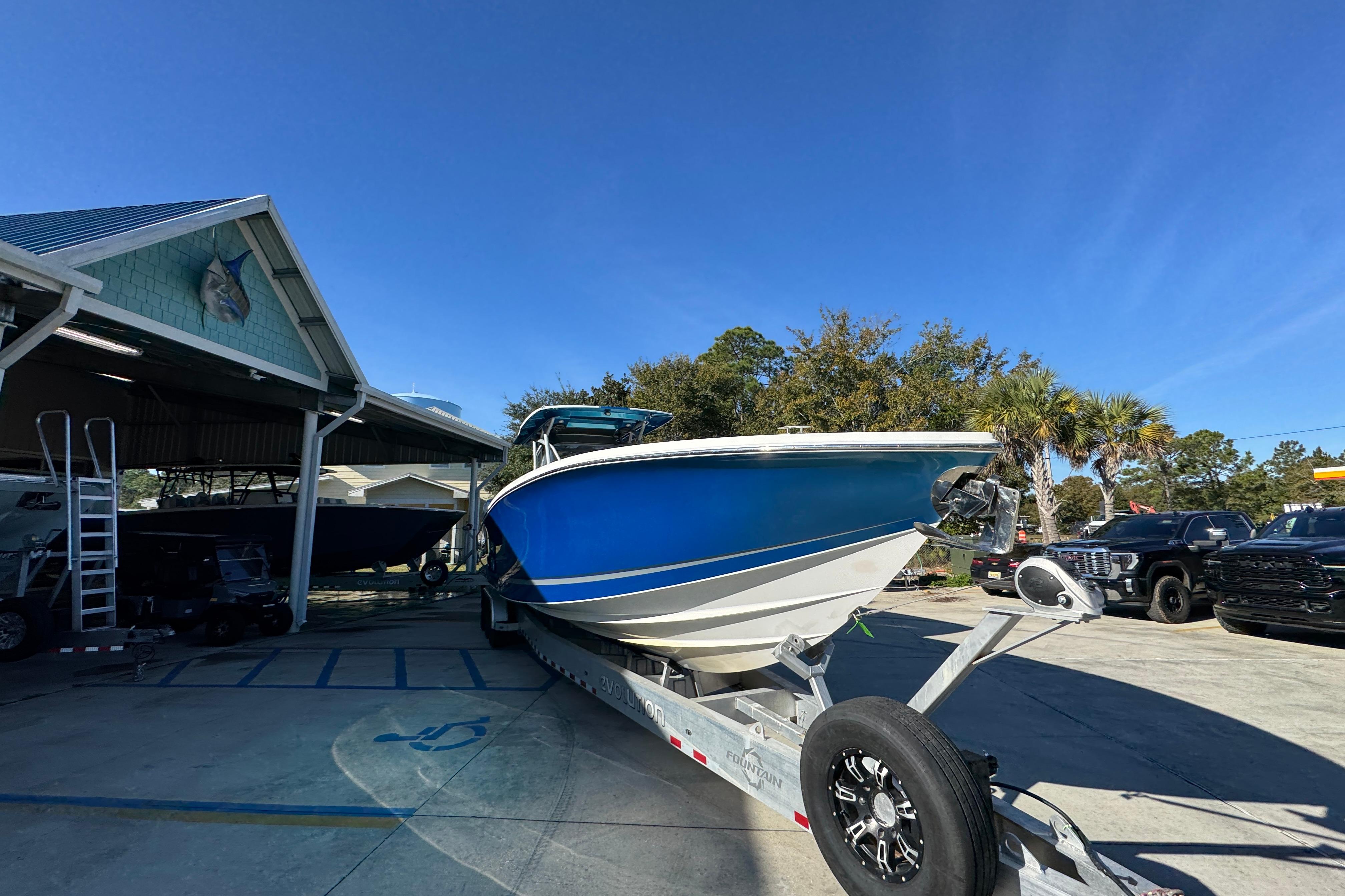 2016 Nor-Tech 390 Sport Center Console boat on trailer, parked outdoors.