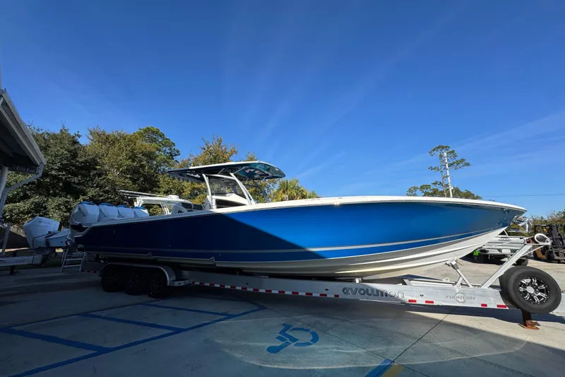  Yacht Photos Pics 2016 Nor-Tech 390 Sport Center Console boat on trailer, vibrant blue hull, parked outdoors.