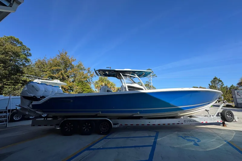  Yacht Photos Pics 2016 Nor-Tech 390 Sport Center Console boat on trailer, blue hull, parked outdoors.