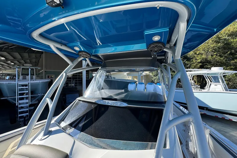  Yacht Photos Pics 2016 Nor-Tech 390 Sport Center Console boat with blue canopy and sleek design.