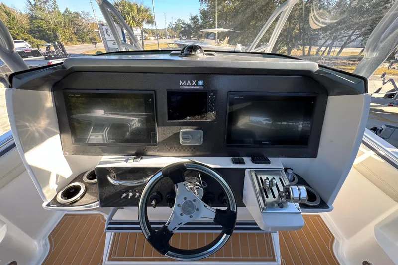  Yacht Photos Pics 2016 Nor-Tech 390 Sport Center Console helm with dual Garmin displays and steering wheel.