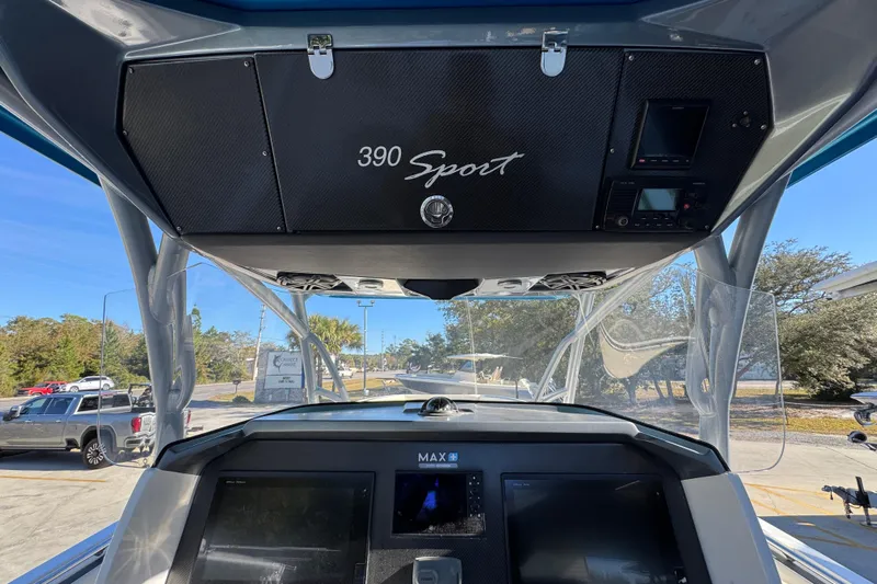 Yacht Photos Pics 2016 Nor-Tech 390 Sport Center Console dashboard with electronics and overhead storage.