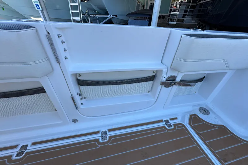  Yacht Photos Pics 2016 Nor-Tech 390 Sport Center Console interior with storage compartments and cushioned seating.