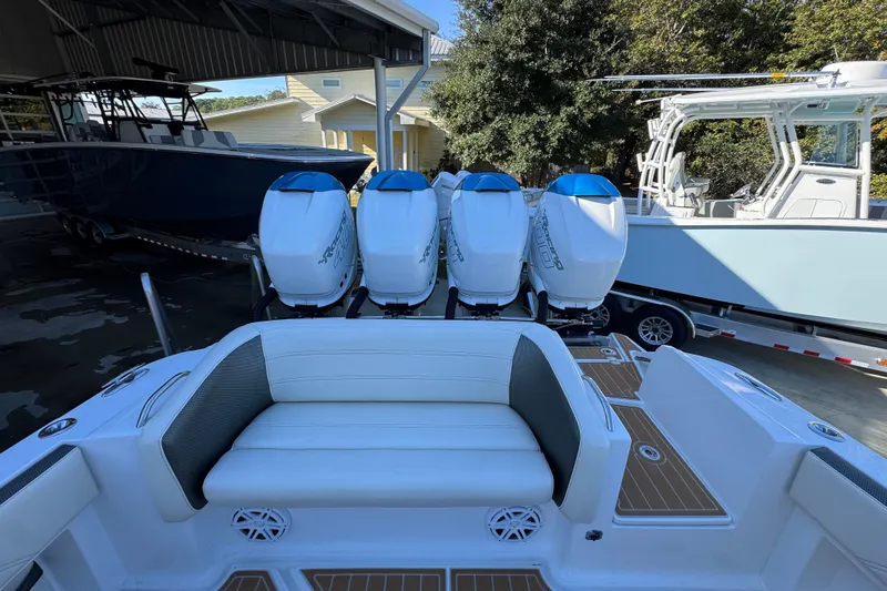  Yacht Photos Pics 2016 Nor-Tech 390 Sport Center Console with four powerful outboard engines, docked under a shelter.