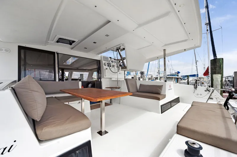 Sabai Sabai Yacht Photos Pics Spacious deck of 2018 Fountaine Pajot Lucia 40 catamaran with comfortable seating and table.