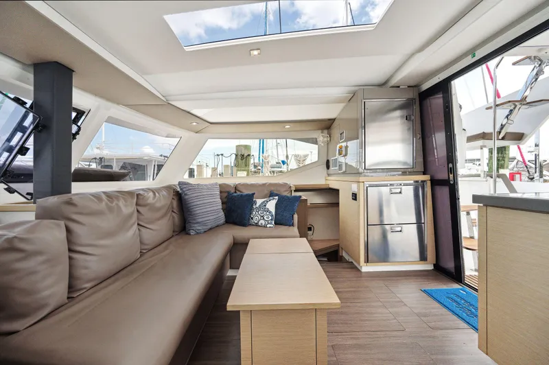 Sabai Sabai Yacht Photos Pics Interior of 2018 Fountaine Pajot Lucia 40 catamaran, featuring modern seating and kitchen area.