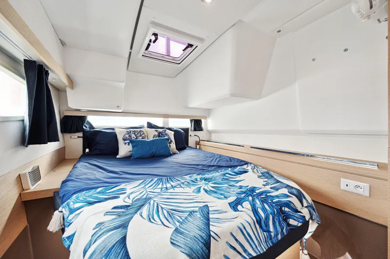 Sabai Sabai Yacht Photos Pics Luxurious cabin interior of 2018 Fountaine Pajot Lucia 40 catamaran with blue bedding.