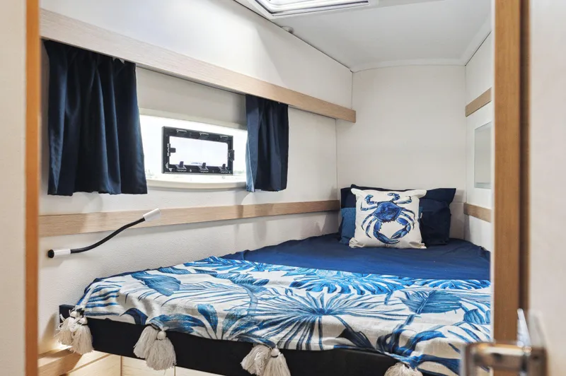 Sabai Sabai Yacht Photos Pics Cozy cabin interior of 2018 Fountaine Pajot Lucia 40 catamaran with nautical decor.