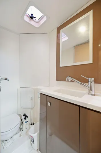 Sabai Sabai Yacht Photos Pics Modern bathroom in 2018 Fountaine Pajot Lucia 40 catamaran, featuring sleek fixtures and ample lighting.