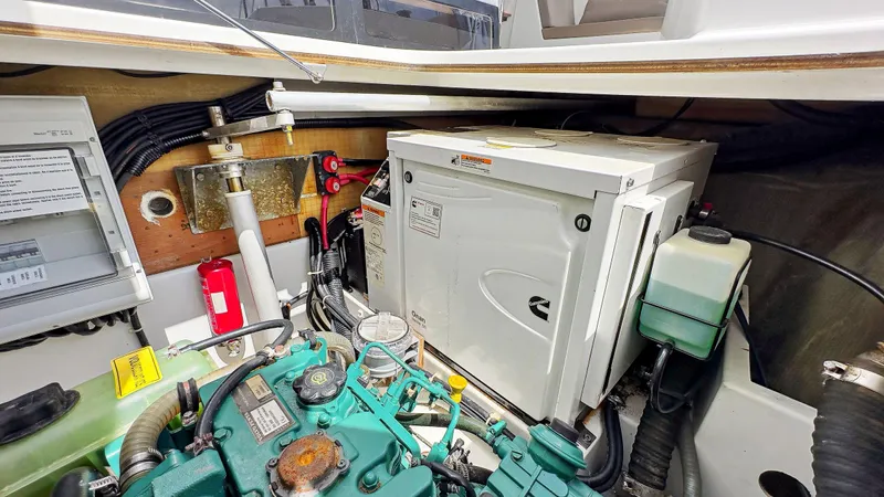 Sabai Sabai Yacht Photos Pics Engine room of 2018 Fountaine Pajot Lucia 40 catamaran with generator and mechanical components.