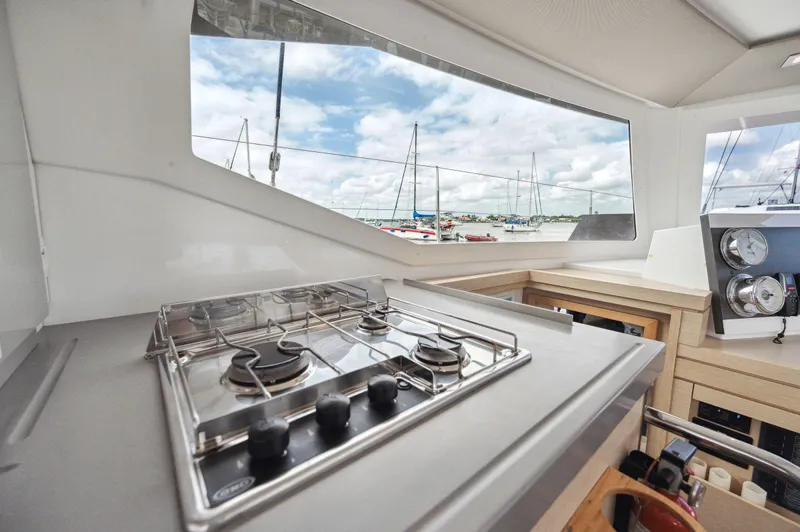 Sabai Sabai Yacht Photos Pics Modern kitchen area on 2018 Fountaine Pajot Lucia 40 catamaran with marina view.