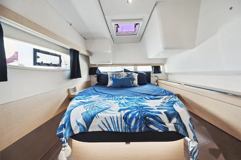 Sabai Sabai Yacht Photos Pics Luxurious cabin interior of 2018 Fountaine Pajot Lucia 40 catamaran with blue bedding.