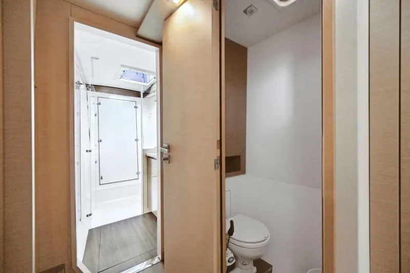 Sabai Sabai Yacht Photos Pics 2018 Fountaine Pajot Lucia 40 yacht bathroom interior with modern design and wooden accents.