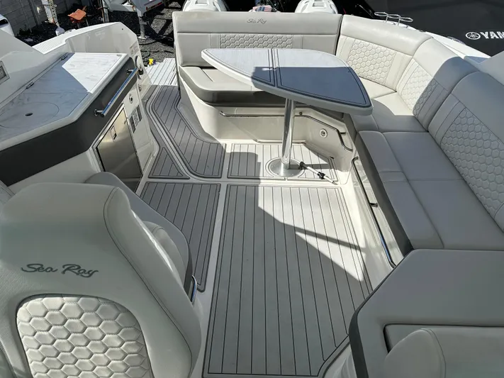  Yacht Photos Pics 2022 Sea Ray Sundancer 320 interior with elegant seating and table arrangement.