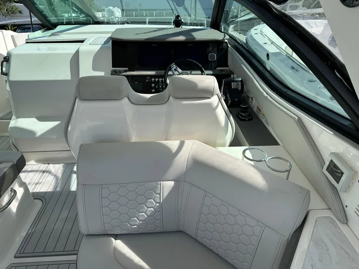  Yacht Photos Pics Interior of 2022 Sea Ray Sundancer 320 boat with luxurious seating and helm.