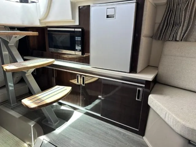  Yacht Photos Pics Interior of 2022 Sea Ray Sundancer 320 with kitchenette, microwave, and compact fridge.