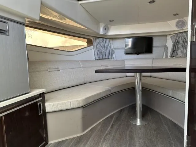  Yacht Photos Pics Interior of 2022 Sea Ray Sundancer 320 with seating, table, and TV.